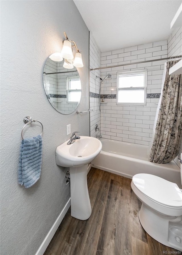 1726 E Evans Ave, Pueblo, CO 81004 - full bathroom with shower / bathtub combination with curtain, wood finished floors, and toilet