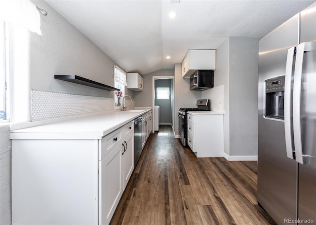 1726 E Evans Ave, Pueblo, CO 81004 - kitchen featuring appliances with stainless steel finishes, dark wood finished floors, a sink, open shelves, and lofted ceiling