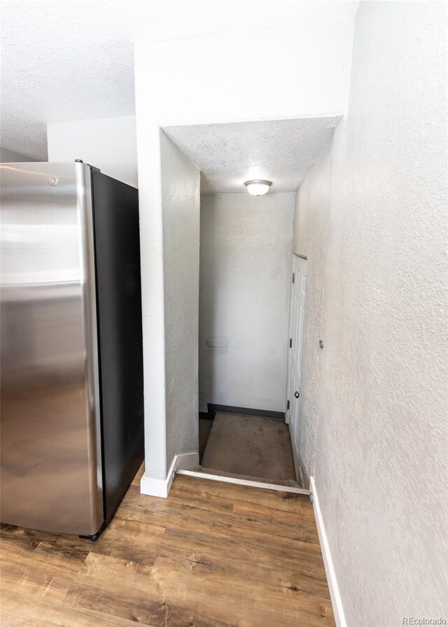 1726 E Evans Ave, Pueblo, CO 81004 - hallway with a textured wall, wood finished floors, baseboards, and a textured ceiling