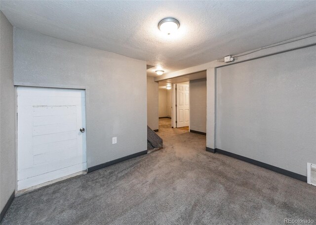 1726 E Evans Ave, Pueblo, CO 81004 - carpeted spare room with baseboards and a textured ceiling