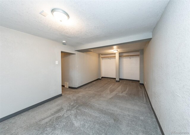 1726 E Evans Ave, Pueblo, CO 81004 - unfurnished bedroom with carpet floors, baseboards, and a textured ceiling