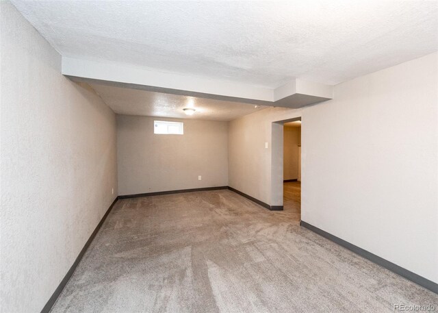 1726 E Evans Ave, Pueblo, CO 81004 - below grade area featuring carpet, a textured ceiling, and baseboards