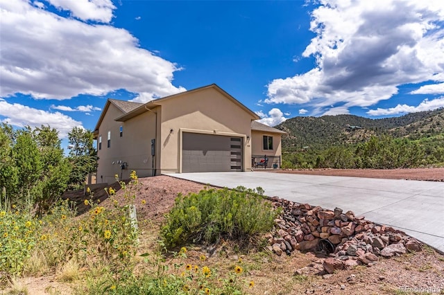 view of property exterior featuring a mountain view and a garage