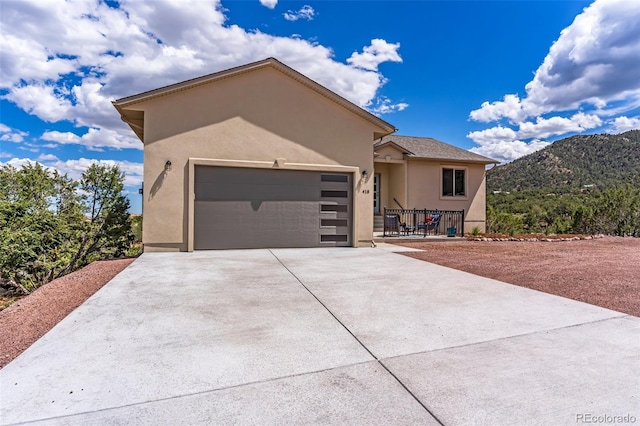 view of front of home with a garage and a mountain view