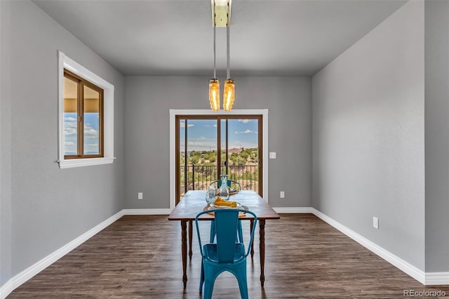 unfurnished dining area featuring a chandelier and dark hardwood / wood-style floors