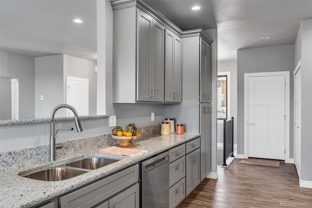 kitchen featuring dishwasher, gray cabinets, light stone countertops, and dark hardwood / wood-style floors