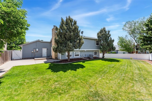 1606 S Flanders Way, Aurora, CO 80017 - back of house with cooling unit, a gate, and a chimney