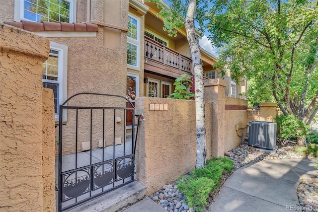 8747 Mesquite Row, Lone Tree, CO 80124 - exterior space featuring a gate, stucco siding, and a balcony