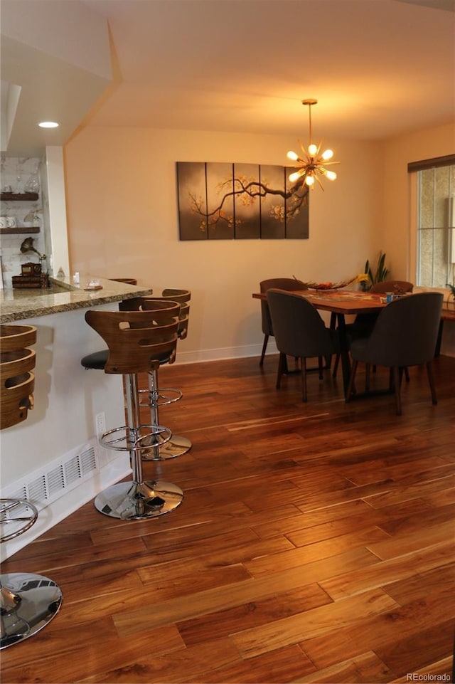 8747 Mesquite Row, Lone Tree, CO 80124 - dining area with wood finished floors and a chandelier