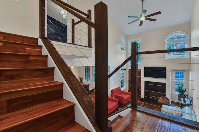 8747 Mesquite Row, Lone Tree, CO 80124 - stairway featuring healthy amount of natural light, ceiling fan, wood finished floors, and a fireplace