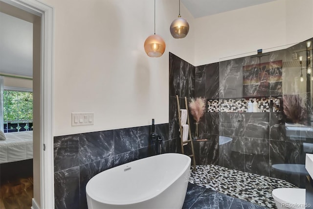 8747 Mesquite Row, Lone Tree, CO 80124 - bathroom with tile walls, a freestanding tub, walk in shower, marble finish flooring, and wainscoting