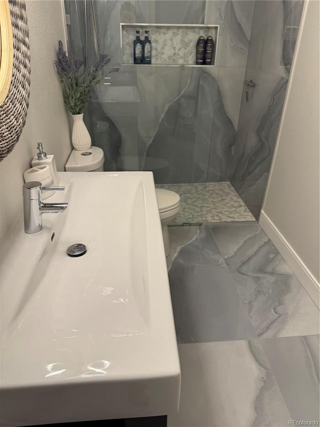 8747 Mesquite Row, Lone Tree, CO 80124 - full bathroom with a marble finish shower, marble finish flooring, and vanity