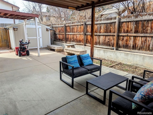 view of patio featuring a storage unit, a fenced backyard, an outdoor structure, and outdoor lounge area