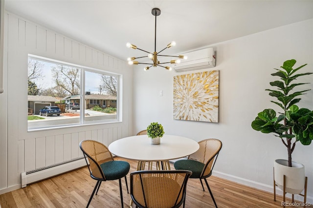 6170 Estes Ct, Arvada, CO 80004 - dining area featuring a wall mounted AC, wood finished floors, baseboards, a baseboard radiator, and a notable chandelier