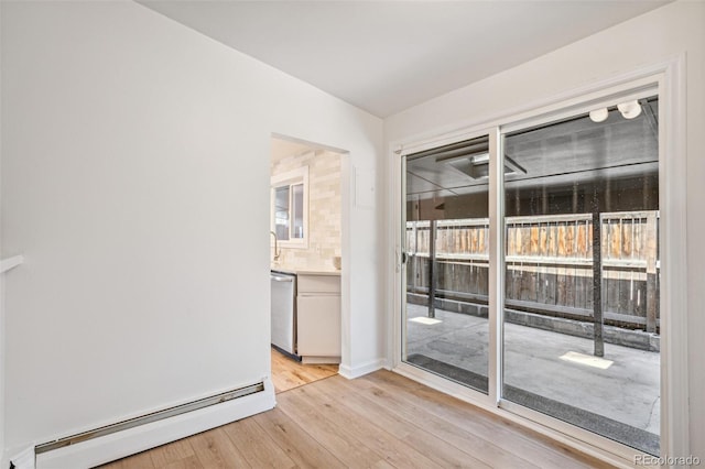 6170 Estes Ct, Arvada, CO 80004 - spare room featuring baseboard heating and light wood-type flooring