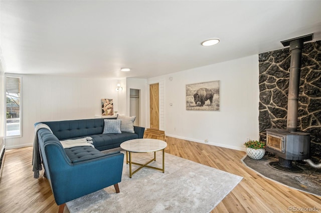6170 Estes Ct, Arvada, CO 80004 - living area with baseboards, wood finished floors, and a wood stove