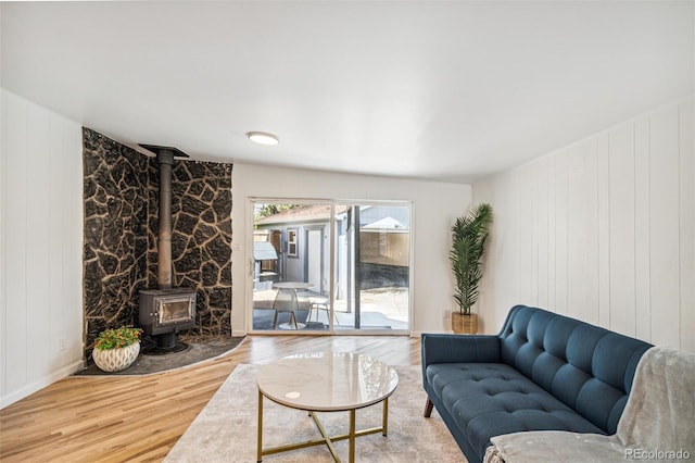 6170 Estes Ct, Arvada, CO 80004 - living room with a wood stove, a decorative wall, and wood finished floors