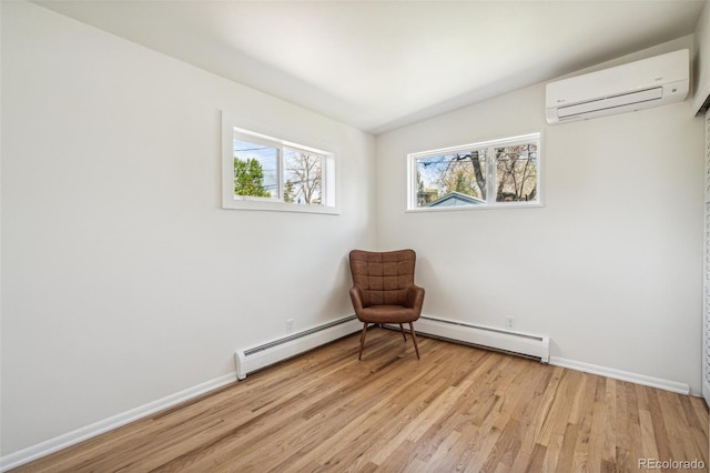 6170 Estes Ct, Arvada, CO 80004 - unfurnished room with baseboard heating, baseboards, a wall unit AC, and light wood finished floors