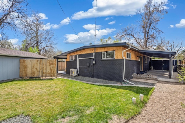 6170 Estes Ct, Arvada, CO 80004 - back of property featuring brick siding, ac unit, fence, and a yard
