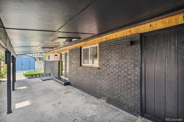 6170 Estes Ct, Arvada, CO 80004 - view of patio featuring a storage unit and an outbuilding