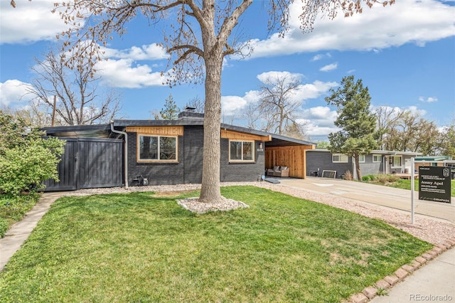 6170 Estes Ct, Arvada, CO 80004 - ranch-style home featuring brick siding, an attached carport, a front yard, a chimney, and driveway