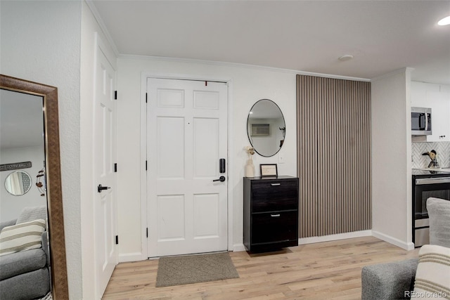 336 N Grant St Unit 206, Denver, CO 80203 - entrance foyer featuring crown molding, baseboards, and light wood-style flooring