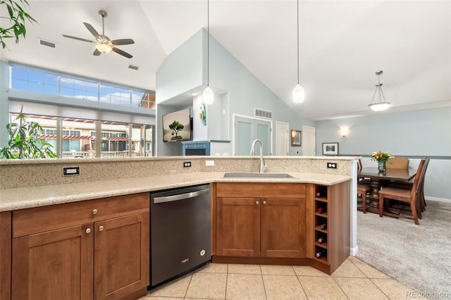 kitchen featuring visible vents, a sink, stainless steel dishwasher, brown cabinetry, and light colored carpet