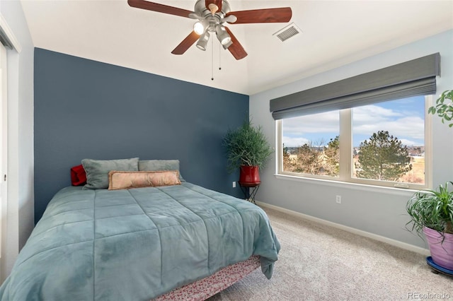 carpeted bedroom featuring visible vents, ceiling fan, and baseboards