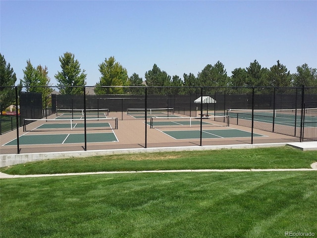 view of sport court featuring a yard and fence