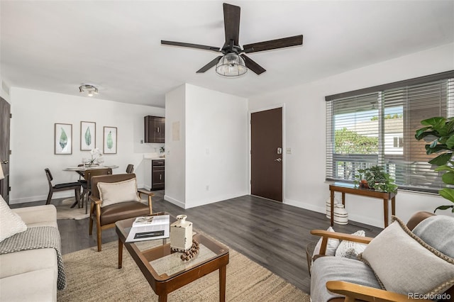 living room with ceiling fan and dark hardwood / wood-style floors