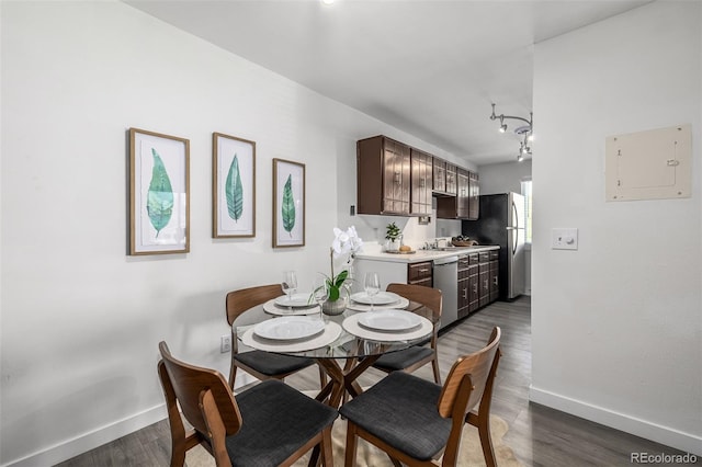 dining space featuring sink and dark hardwood / wood-style flooring