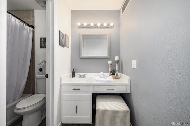 full bathroom featuring vanity, shower / bath combo with shower curtain, and toilet