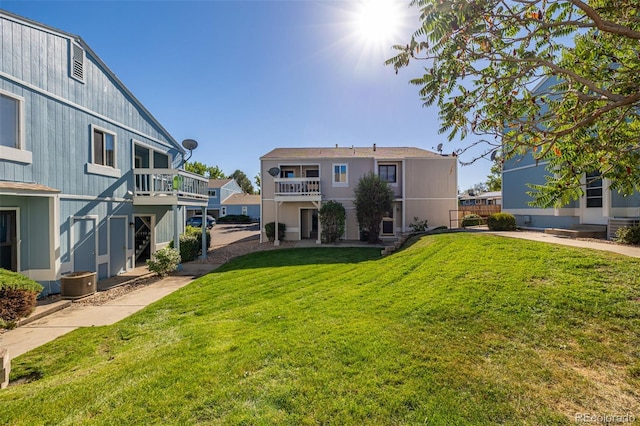 exterior space featuring a yard and central AC