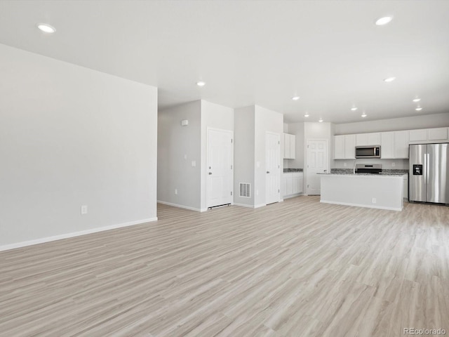 1134 Thunder Pass Rd, Severance, CO 80550 - unfurnished living room featuring light wood-style flooring and recessed lighting