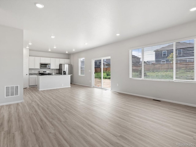 1134 Thunder Pass Rd, Severance, CO 80550 - unfurnished living room with light wood-style flooring and recessed lighting