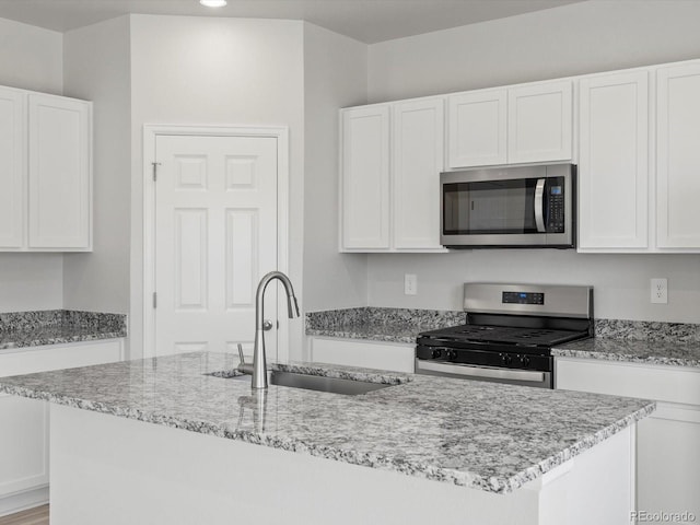 1134 Thunder Pass Rd, Severance, CO 80550 - kitchen with appliances with stainless steel finishes, white cabinetry, light stone counters, and recessed lighting