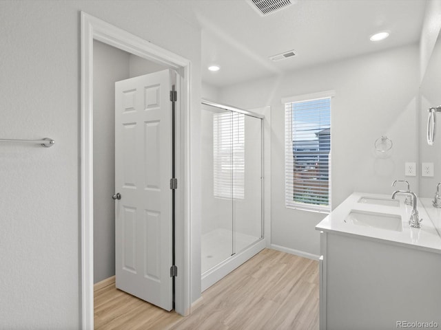 1134 Thunder Pass Rd, Severance, CO 80550 - bathroom with wood finished floors, a shower stall, double vanity, and recessed lighting