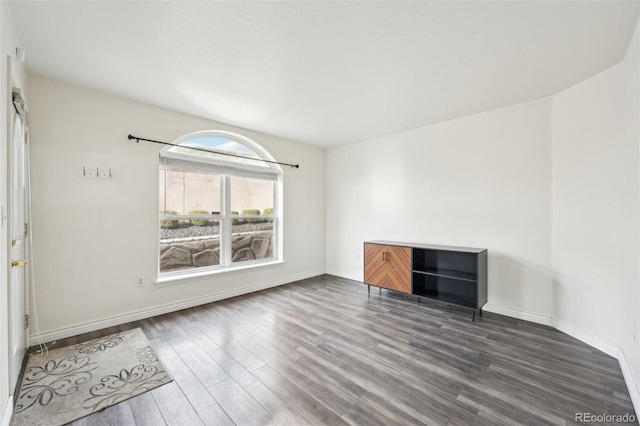 interior space with wood finished floors and baseboards