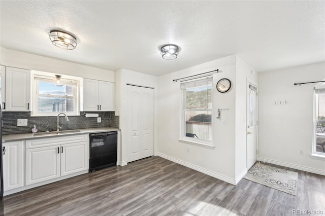 kitchen with dark wood-style floors, white cabinetry, a sink, decorative backsplash, and dishwasher