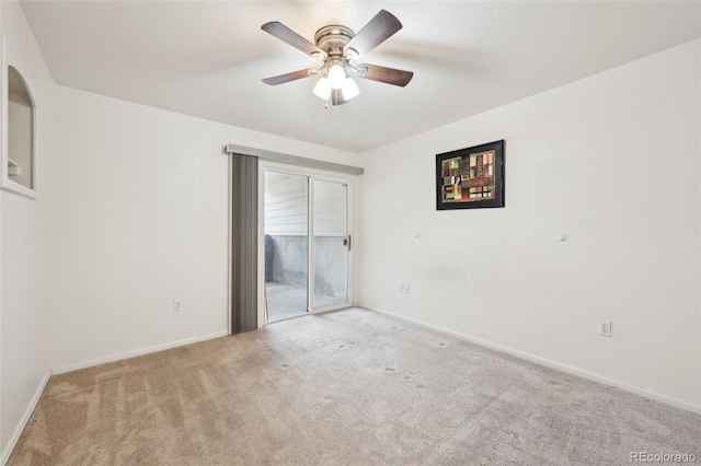 carpeted empty room with baseboards and ceiling fan