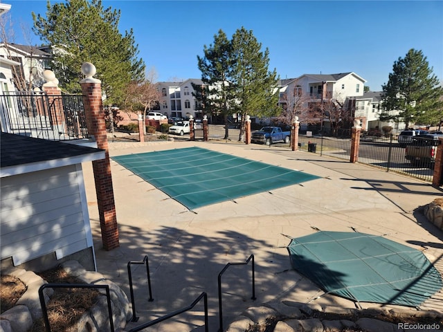 view of pool with a residential view, a patio, and fence