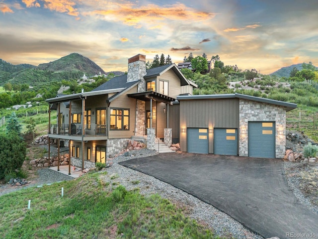 12947 Lazy Dog Ln, Littleton, CO 80127 - modern home featuring stone siding, a mountain view, and a balcony
