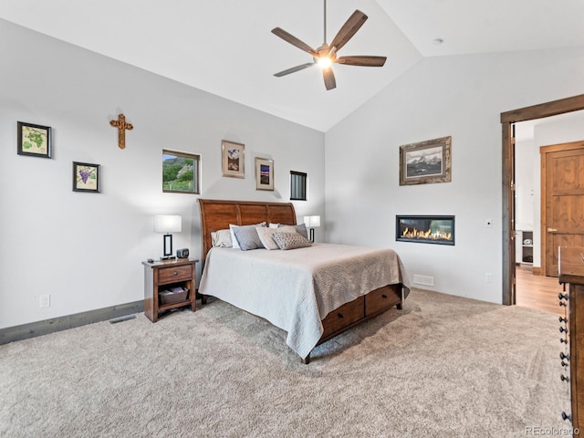 12947 Lazy Dog Ln, Littleton, CO 80127 - carpeted bedroom featuring high vaulted ceiling, a glass covered fireplace, and ceiling fan