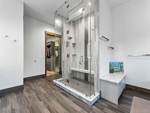 12947 Lazy Dog Ln, Littleton, CO 80127 - full bath with a walk in closet, a shower stall, and vanity