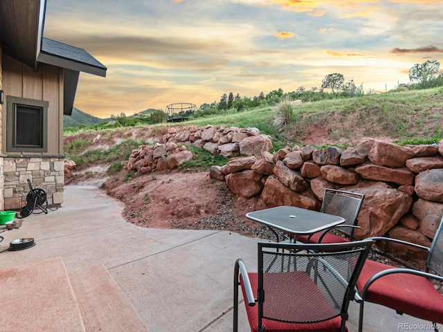 12947 Lazy Dog Ln, Littleton, CO 80127 - patio terrace at dusk featuring a patio area and outdoor dining area