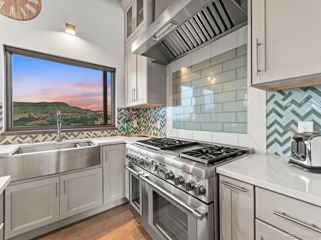 12947 Lazy Dog Ln, Littleton, CO 80127 - kitchen with double oven range, wall chimney exhaust hood, and light countertops
