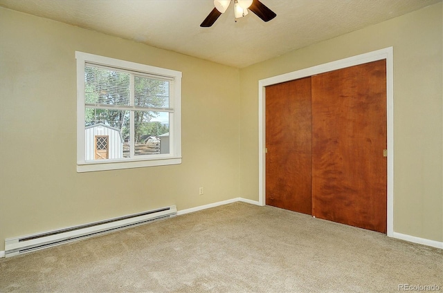 620 James Pl, Buena Vista, CO 81211 - unfurnished bedroom with a baseboard radiator, carpet floors, a closet, and ceiling fan