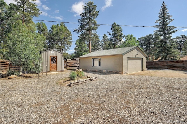 620 James Pl, Buena Vista, CO 81211 - detached garage featuring concrete driveway and a storage shed