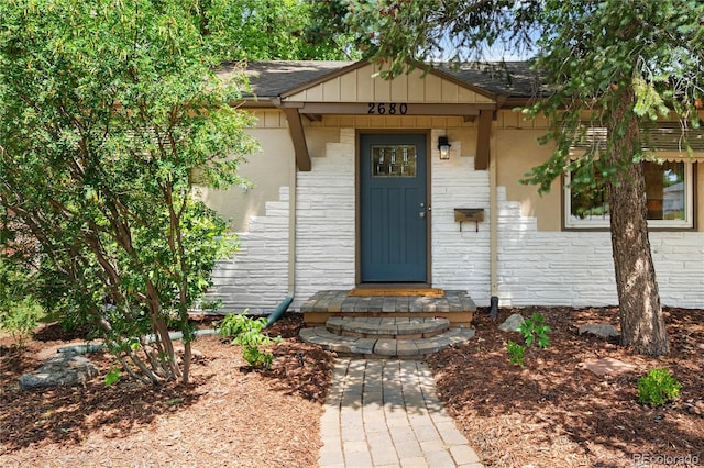 2680 S Garfield Cir, Denver, CO 80210 - doorway to property with a shingled roof and brick siding