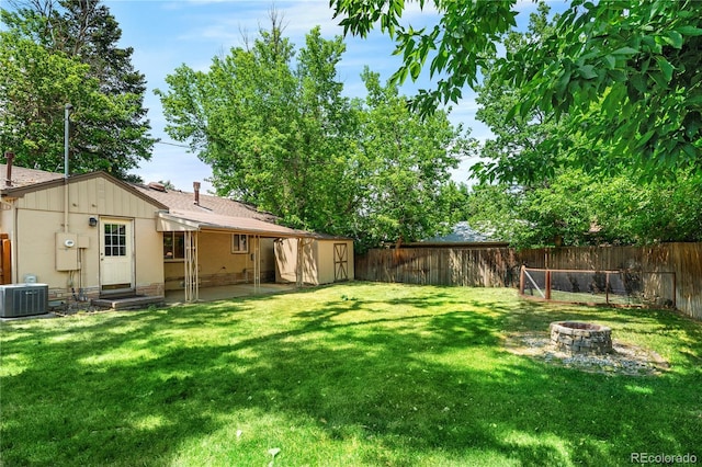 2680 S Garfield Cir, Denver, CO 80210 - fenced backyard featuring a fire pit, a shed, and entry steps